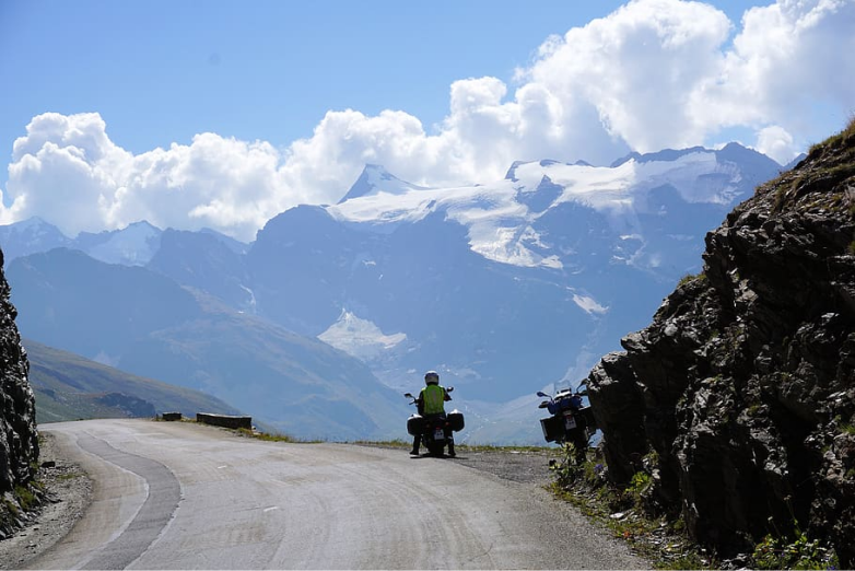 man resting on his motorcycle on Col d'Iseran